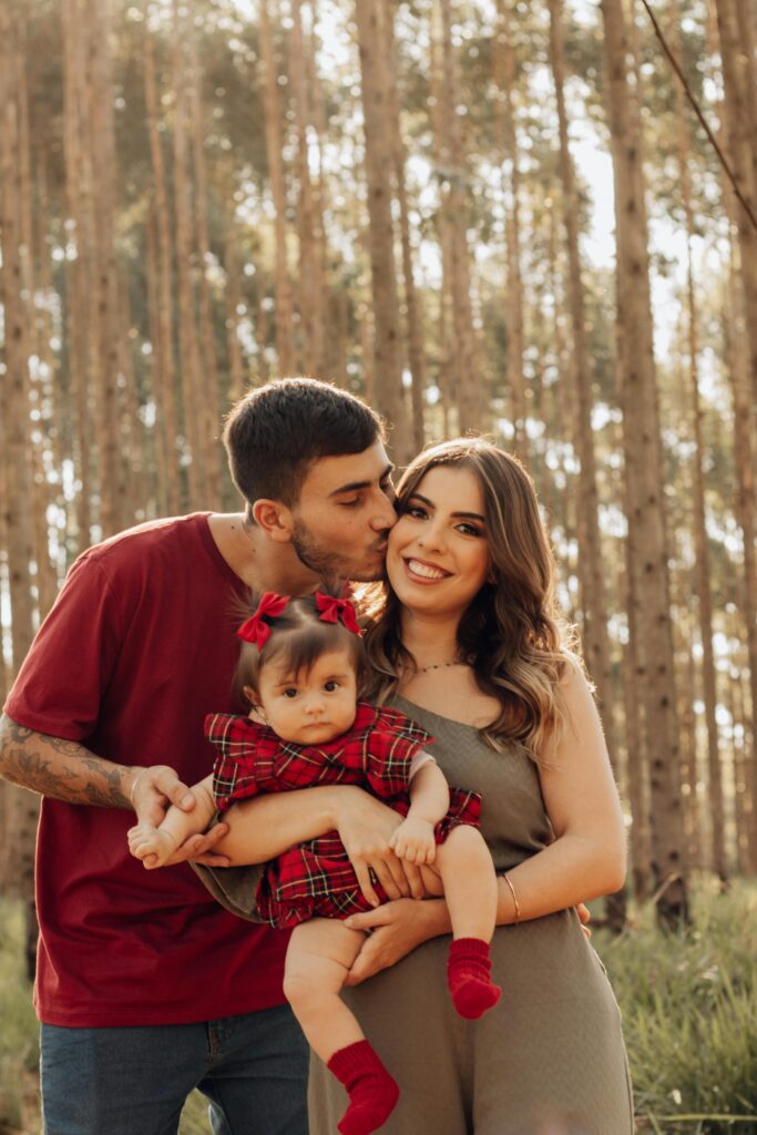 Happy family with baby in forest of São Paulo. Natural, loving moment captured outdoors.